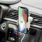 A phone holder in a car displaying a phone with a light green charging icon, featuring a sleek silver design.