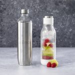 A drink bottle featuring a stainless steel exterior and a clear, infused design with raspberries and lime inside.