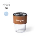 A drink cup featuring a clear borosilicate glass body with a brown leather sleeve and a black lid.