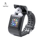 A smartwatch in black with a touchscreen display and white earbuds stored in the top. It features a branded logo.