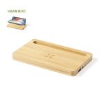 A bamboo wireless charger with a slot for a phone and a branding logo on the surface.