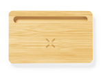 A bamboo organiser charger with a sleek design and a small groove for easy device placement.