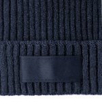 A navy blue beanie with a ribbed texture and a blank label patch.