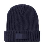 A navy blue ribbed beanie hat with a folded cuff and a logo patch on the front.