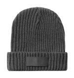 A grey beanie hat with a ribbed texture and a small logo patch on the band.