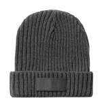 A grey ribbed beanie with a folded cuff and a branding label on the front.