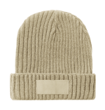 A beige beanie hat with a ribbed texture and a blank branding area on the front.