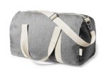 A grey bag with canvas straps and a zip closure, featuring a logo.