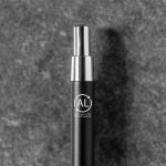 A metal pen in black with a silver tip and a logo highlighting its recycled material.
