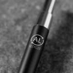 A metal pen with a black body and a shiny silver clip, featuring a recycling logo.