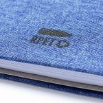 A blue notebook with a textured cover and a small logo on the front. It features a metallic binding.