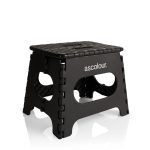 A black utility stool with a textured top and cut-out sides, featuring a logo on one side.