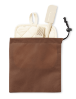 A brown storage pouch containing a cream spatula and a cream pot holder. The pouch has a drawstring closure and branding.