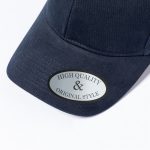 A navy cap featuring a curved peak and a logo on the front. It has a smooth fabric texture.
