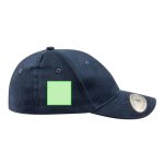 A navy cap with a green blank patch on the side and a branded emblem on the front.