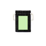 A drawstring bag in black with a green blank centre and natural-coloured cord. The bag features a simple design.