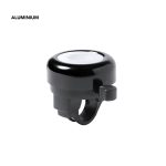 A black aluminium bike bell with a smooth white top surface and a lever for ringing.