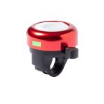 A red bicycle bell with a shiny surface and a black mounting bracket. It features a lever for ringing.