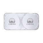 A rectangular sunshade featuring two circular sections with a logo and a design of a cabin against a snowy backdrop.