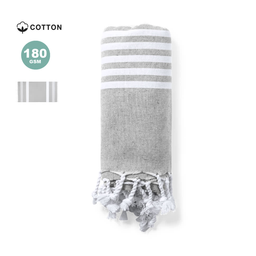 A grey and white striped towel pareo made of cotton, featuring fringed ends. It includes a logo. A grey and white striped towel pareo made of cotton, featuring fringed ends. It includes a logo.
