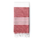 A folded towel in a reddish hue with white stripes and fringe detail at the bottom, featuring a branded logo.