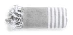 A folded grey towel with white stripes and tassels at one end. It has a simple, textured design.