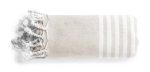 A rolled towel in beige with white stripes and tassels on one end, featuring a logo.