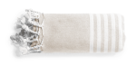 A folded beige towel pareo with white stripes and tassels, featuring a logo on the edge.