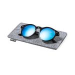 Sunglasses with black frames and blue mirrored lenses resting on a grey felt pouch, featuring a logo.