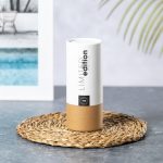 A cylindrical packaging for sunglasses, featuring white and brown elements with a logo and seasonal branding.