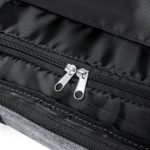 A close-up of the zippered opening of a black and grey wheeled bag, featuring silver zipper pulls.