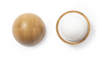 A round lip balm with a textured bamboo-like exterior and a white balm interior. The product features branding.