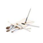 A set of six eyeshadow applicators in a cream pouch, featuring soft bristles and silver accents.