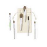 A set of six eyeshadow applicators in various sizes with grey and white handles, presented in a natural fabric pouch.