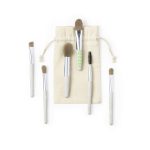A set of six eyeshadow applicators with cream and green handles, packaged in a cloth pouch.