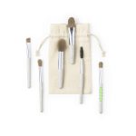 A set of five eyeshadow applicators with textured handles, housed in a cream-coloured pouch.