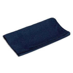 A folded neck scarf in navy blue with a white polka dot pattern, featuring a logo on one side.