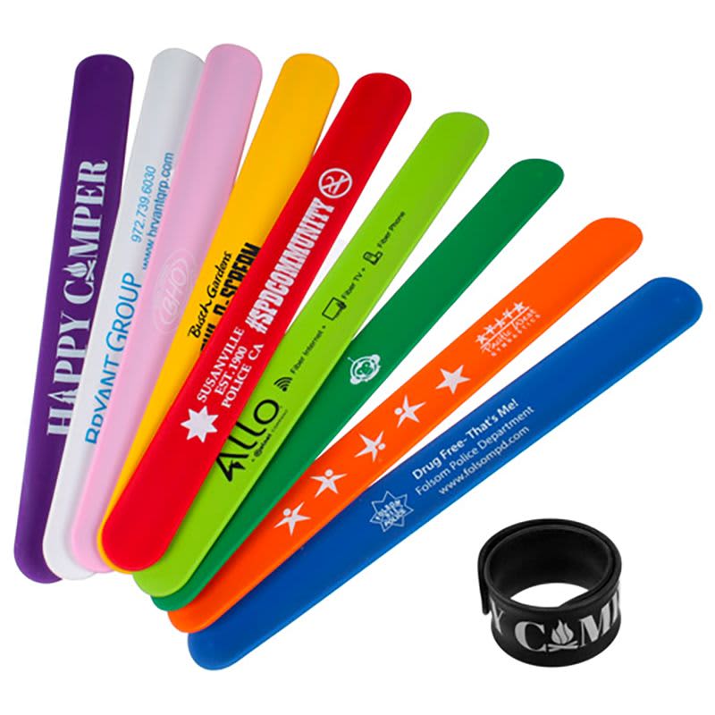 A set of colourful silicone snap wristbands in various hues including purple, pink, orange, blue, green, and yellow, with a black wristband. Silicone Snap Wristband - Image 1