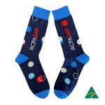 A pair of navy blue socks featuring multicoloured polka dots and a logo, with blue cuffs.