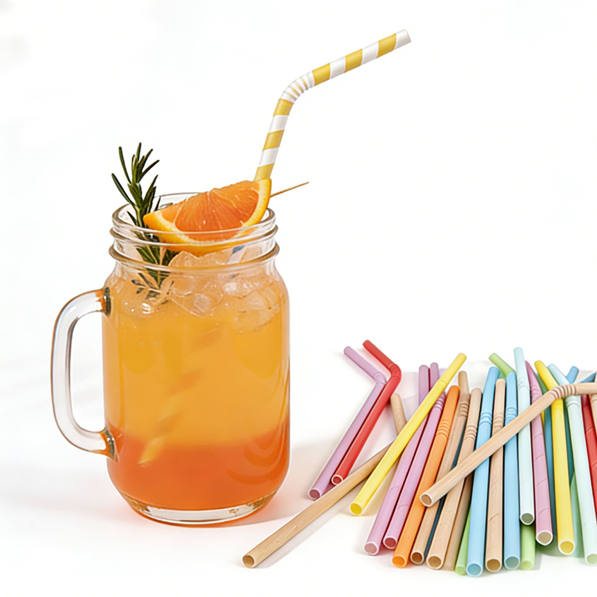 A drink bottle filled with orange liquid, ice, and a yellow-striped paper straw, surrounded by colourful disposable straws. Custom Disposable 3-ply Bendable Drinking Paper Straw - Image 1