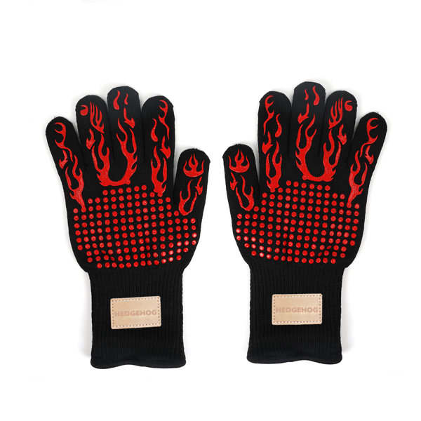 Heat resistant gloves featuring a black design with red flame patterns and textured grip on the palms. Heat resistant gloves featuring a black design with red flame patterns and textured grip on the palms.