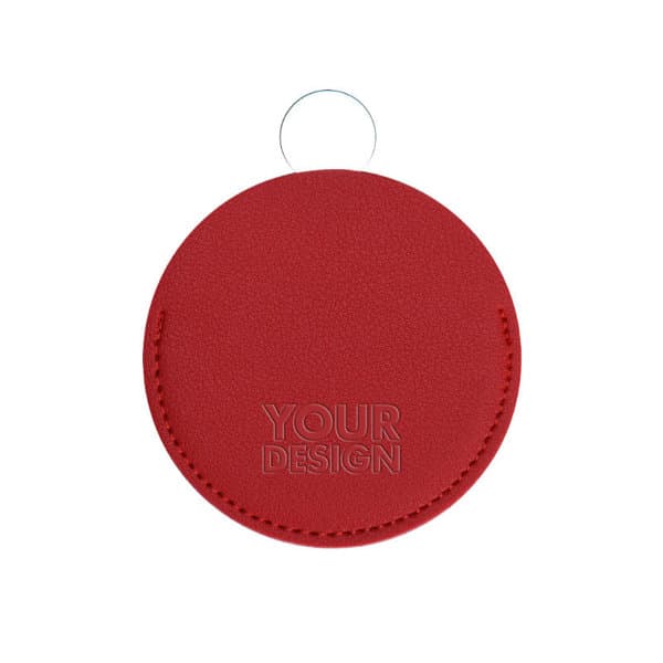 A round cosmetic mirror with a red PU leather cover, featuring a keyring and a logo or branding. A round cosmetic mirror with a red PU leather cover, featuring a keyring and a logo or branding.