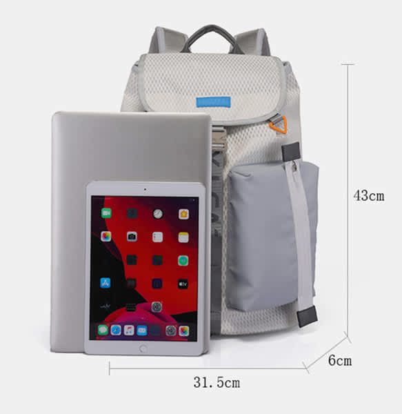 A lightweight grey drawstring backpack with a tablet and a silver laptop beside it, featuring a logo on the front. A lightweight grey drawstring backpack with a tablet and a silver laptop beside it, featuring a logo on the front.