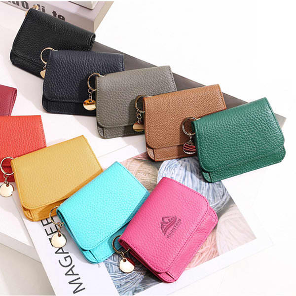 A row of small RFID blocking wallets in various colours, including black, green, brown, turquoise, pink, and yellow. Each wallet has a keyring. A row of small RFID blocking wallets in various colours, including black, green, brown, turquoise, pink, and yellow. Each wallet has a keyring.