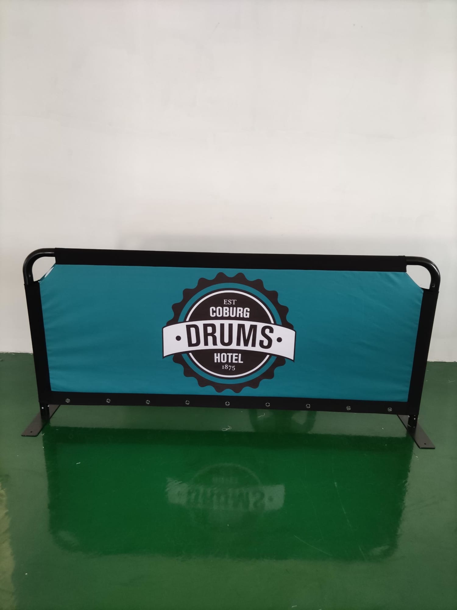 A teal crowd barrier featuring a black frame and a logo in the centre. Crowd Barrier 2040mm x 915mm - Image 1