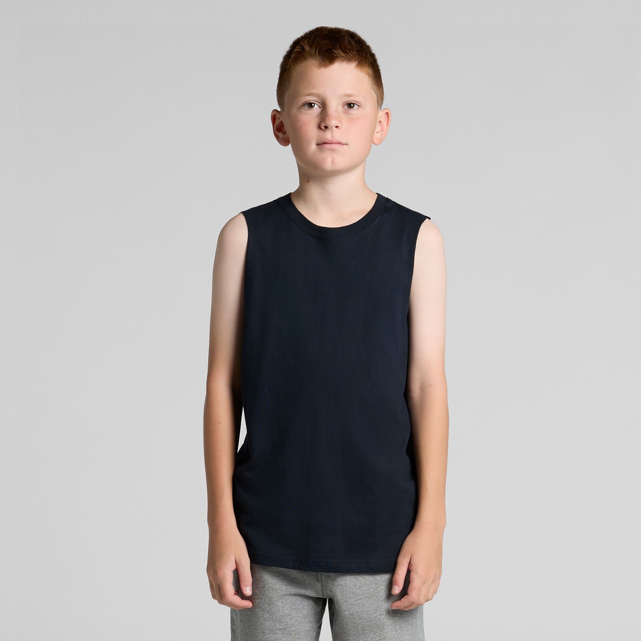 A youth sleeveless tank in navy blue, featuring a minimalistic design and a brand logo. A youth sleeveless tank in navy blue, featuring a minimalistic design and a brand logo.