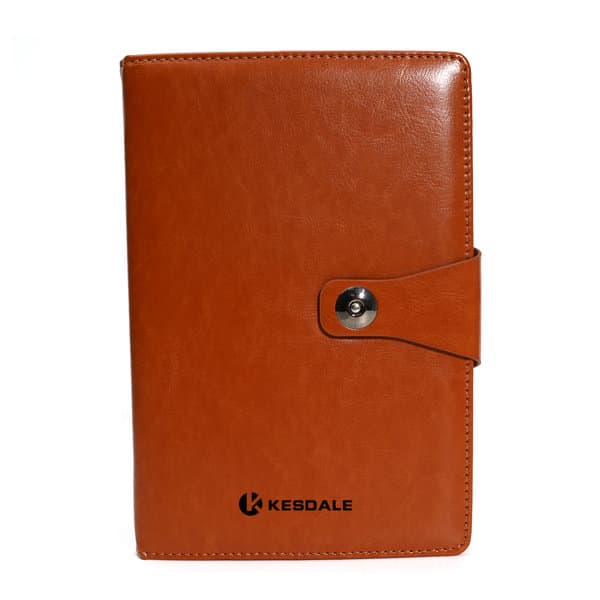 A5 business spiral notebook in brown synthetic leather with a buckle closure and a logo on the cover. A5 business spiral notebook in brown synthetic leather with a buckle closure and a logo on the cover.