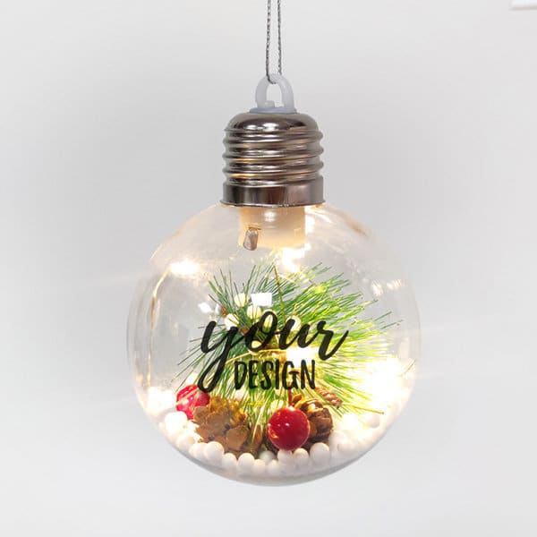 A clear LED light Christmas ornament ball filled with decorative elements, featuring a silver cap and cord for hanging. A clear LED light Christmas ornament ball filled with decorative elements, featuring a silver cap and cord for hanging.