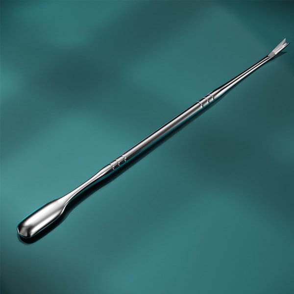 A stainless steel cuticle pusher with a smooth, shiny finish and a double-ended design on a teal background. A stainless steel cuticle pusher with a smooth, shiny finish and a double-ended design on a teal background.