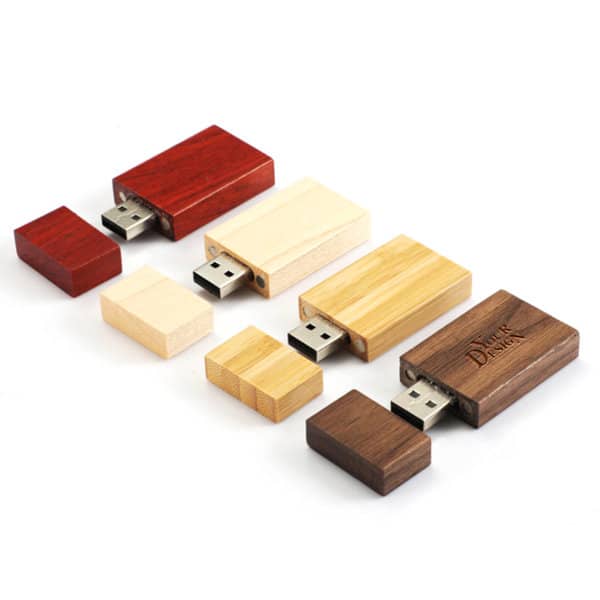 A collection of wooden USB flash drives in red, cream, brown, and yellow, featuring a logo on one. A collection of wooden USB flash drives in red, cream, brown, and yellow, featuring a logo on one.